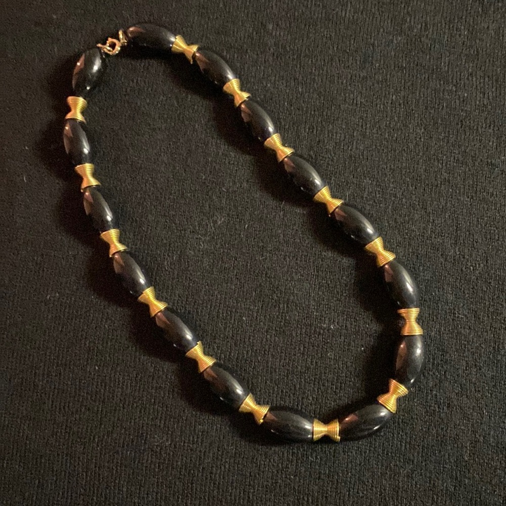 Black with gold colored grommets beaded necklace